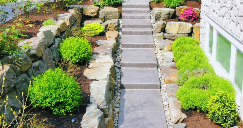 A simple installation of paving stones and gardens. A drainage solution in West Island of Montreal.