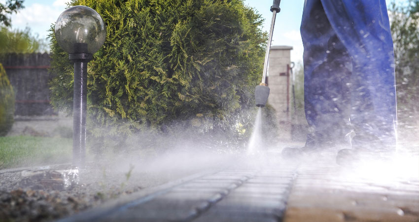 A Valleycat Landscaping expert providing pressure washing services in the West Island